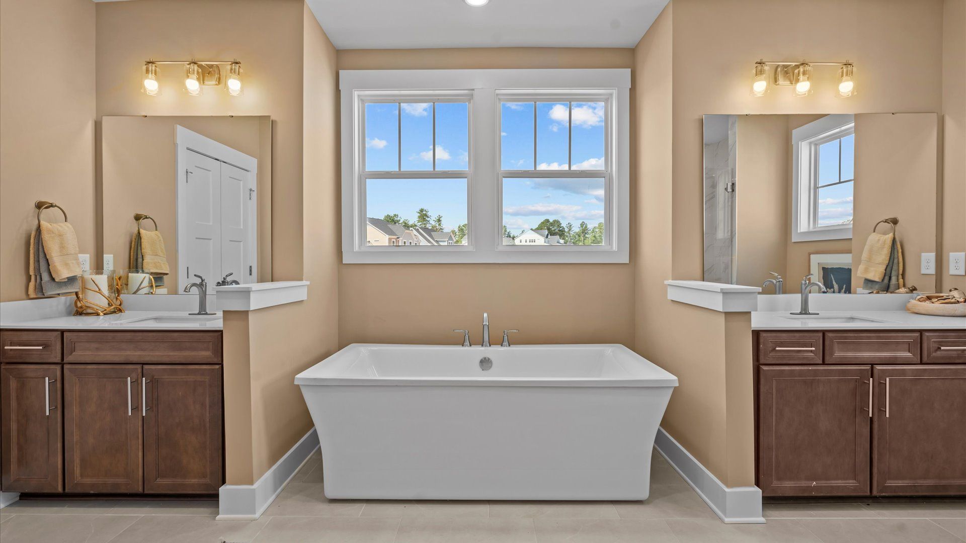 Memorable mornings begin in this elegant primary bathroom with walk-in shower and dual sinks located in Seneca, SC
