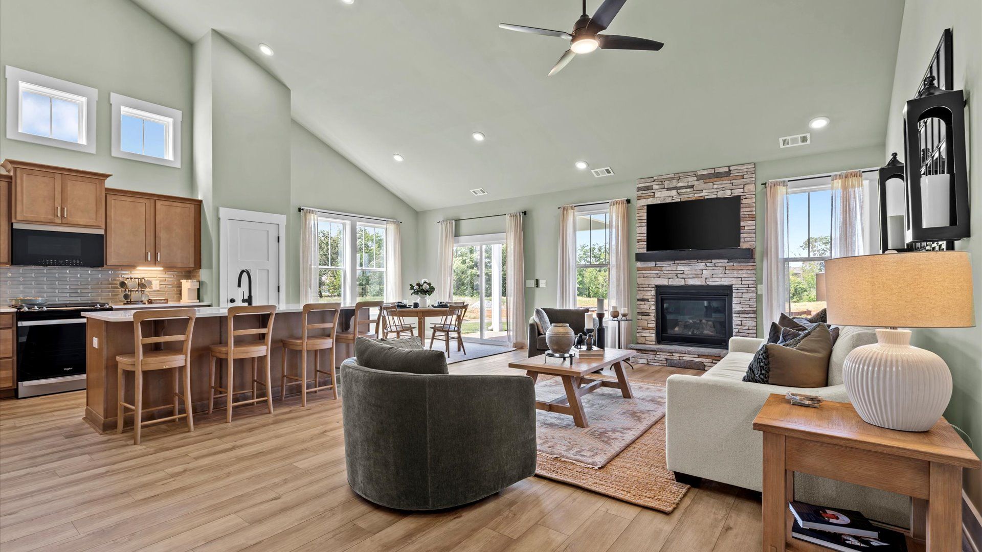 Exceptional open-concept family room with lots of natural light, high ceilings, and hardwood floors, at Harrier Point