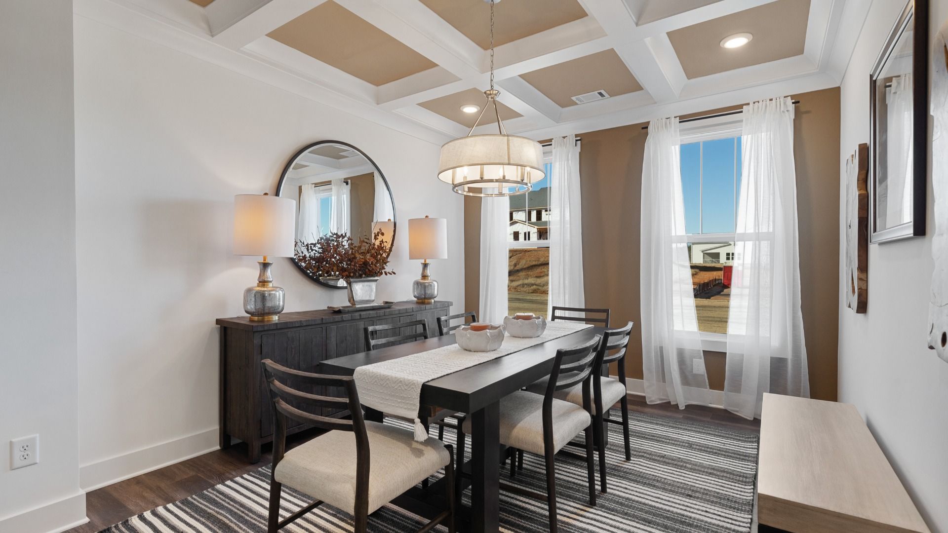 Exclusive dining area with sophisticated lighting, large table, and hardwood floors located at Harrier Point in Woodruff, SC