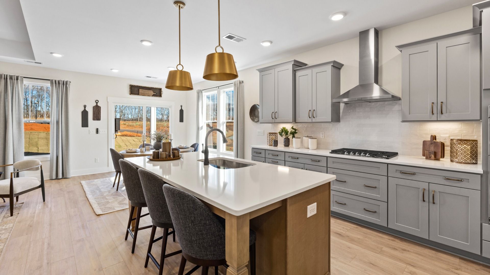 Vibrant kitchen layout with a center island, refined finishes, open-concept flow, and lovely breakfast area at Harrier Point
