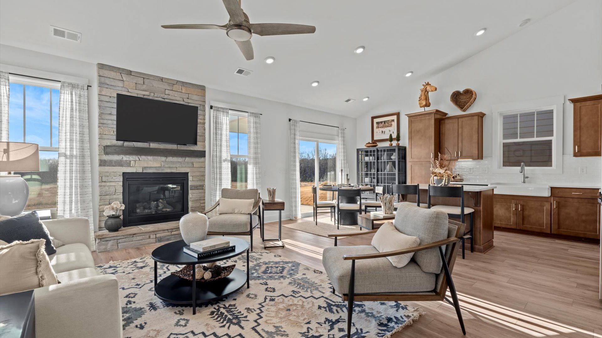 Exceptional family room with hardwood flooring, natural light, and open-concept at Harrier Point in Woodruff, SC