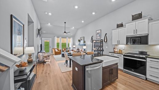 Elevated entry way with hardwood flooring, access to office space, and bright white walls at Aspen Ridge by DRB Homes
