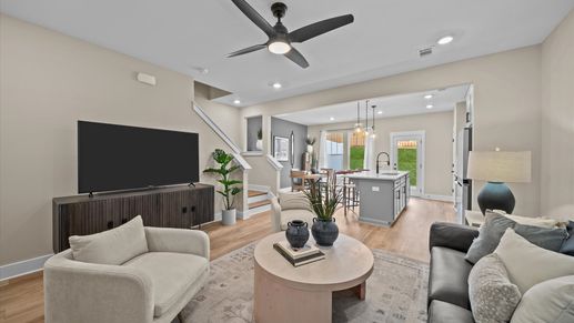 Hardwood flooring family room with elevated ceilings in two story townhome at Saluda Crossing by DRB Homes in Piedmont, SC