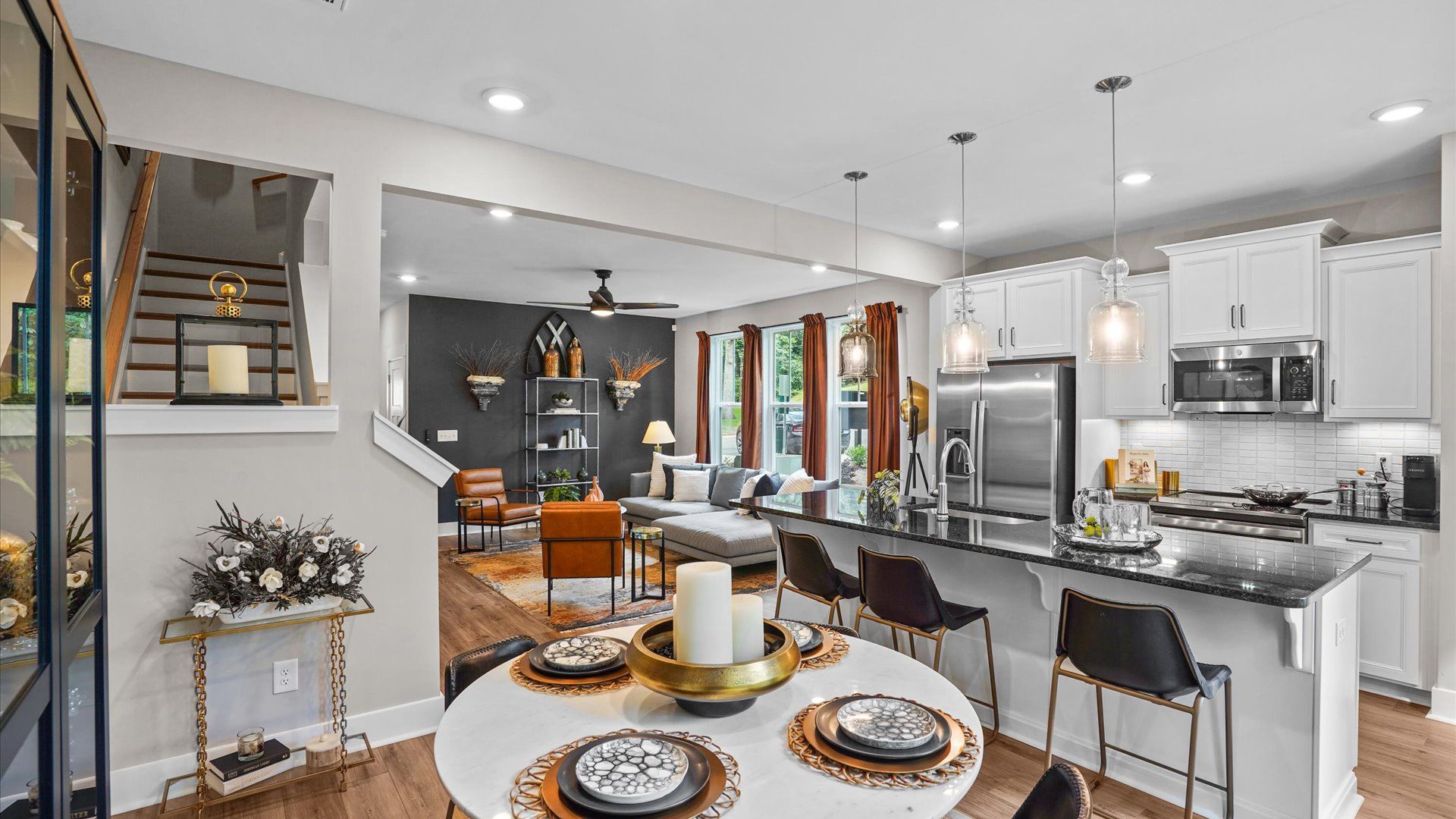 Black and white modern kitchen with granite countertops and tiled backsplash at Clayton Crossing by DRB Homes in Arden, NC