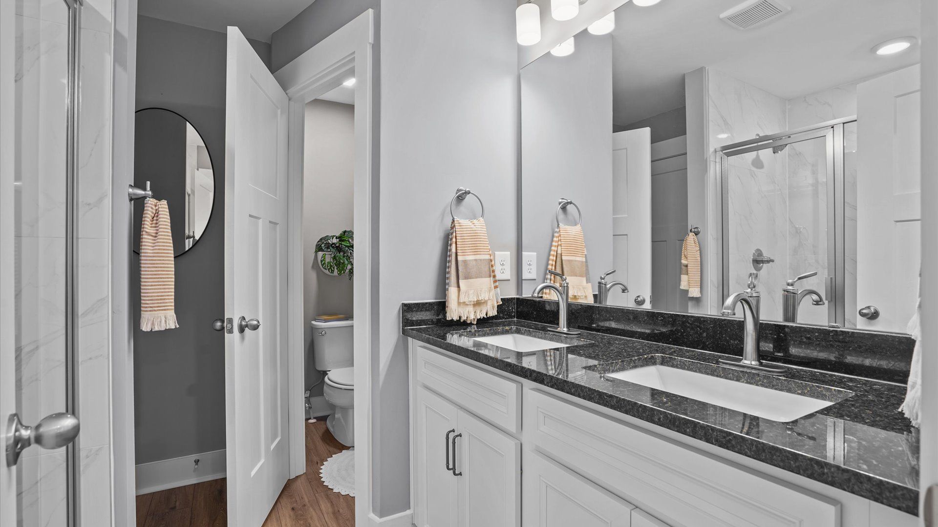 Primary bathroom with double sink vanity with granite countertops at Clayton Crossing by DRB Homes in Arden, NC