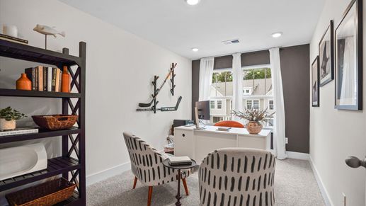 Plush carpeted, cozy secondary bedroom with large windows and elevated ceilings at Clayton Crossing by DRB Homes in Arden, NC