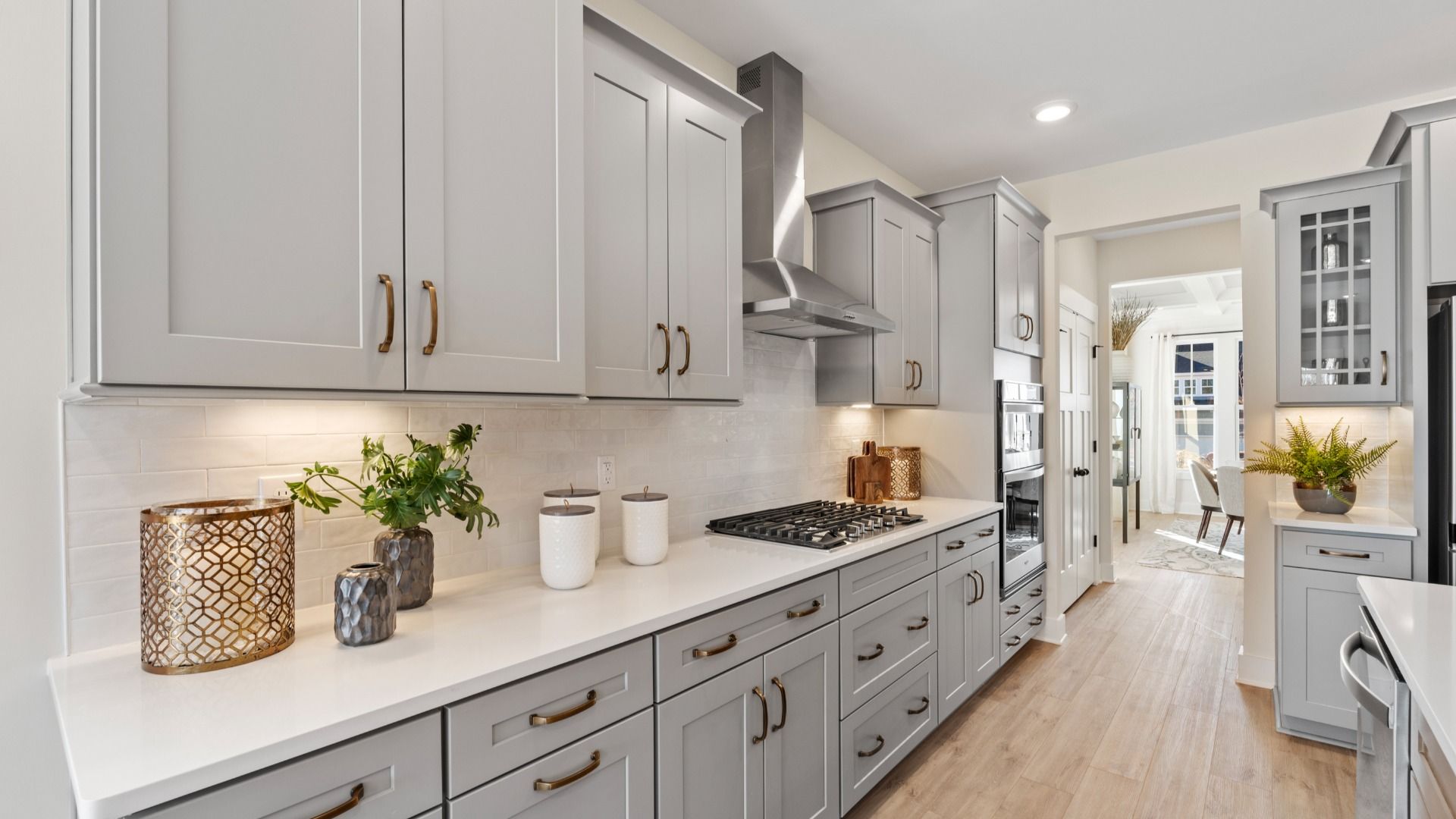 Superior kitchen with quartz countertops, pendant lighting, and a generously sized island