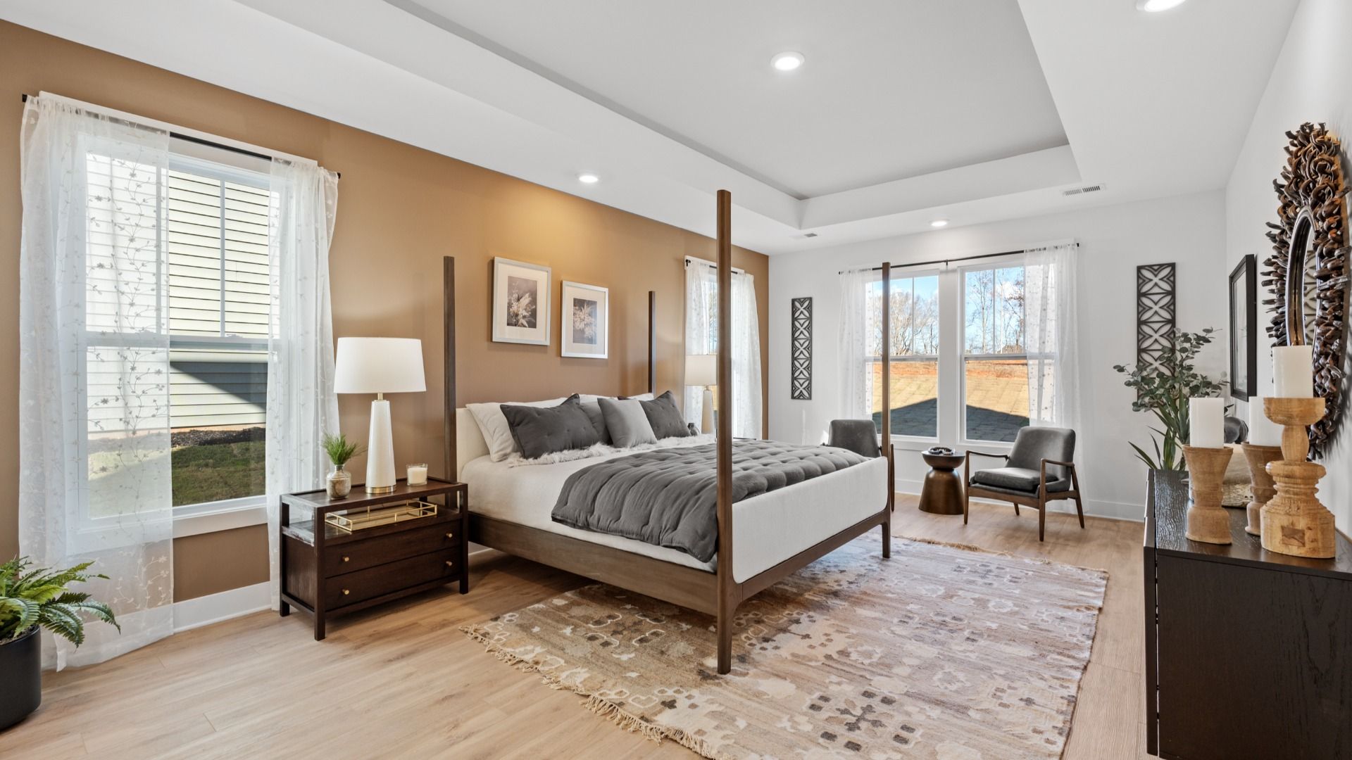 Elegant primary suite with tray ceiling and walk-in closet in this top-notch home