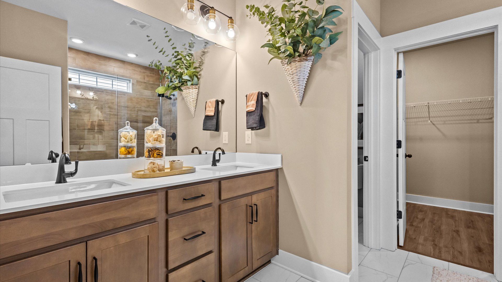 Exceptional en-suite with dual vanity and glass-enclosed walk-in shower for superior everyday comfort