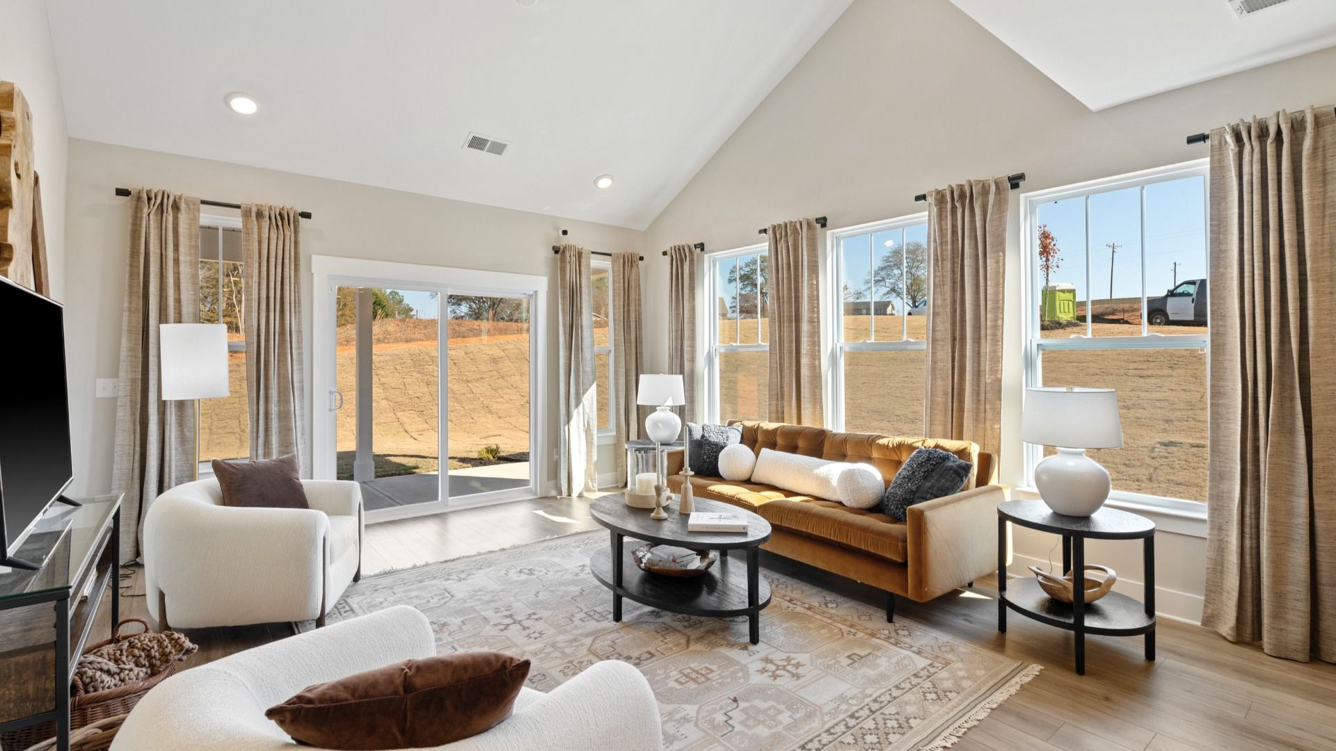 Vibrant family room with high-impact two-story ceilings and thoughtful layout for entertaining