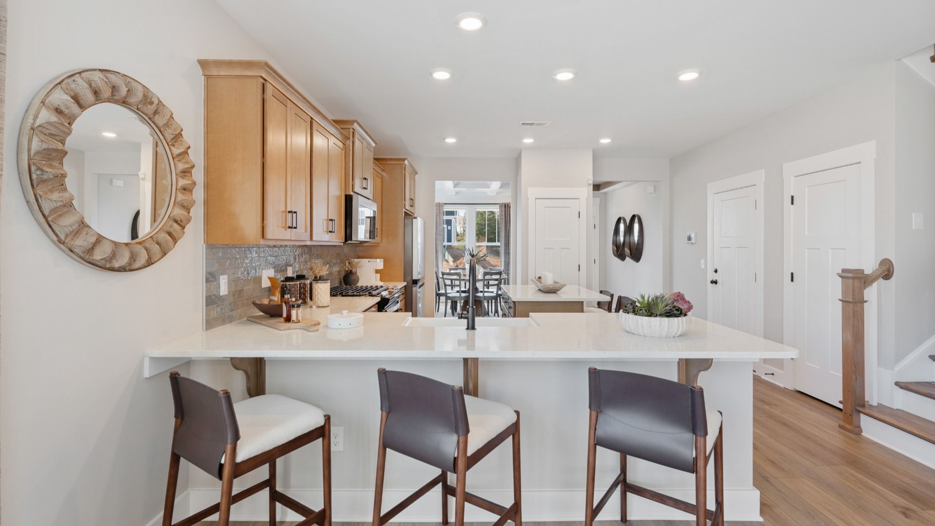 Superior craftsmanship shines in this modern kitchen with a space-saving island and open flow
