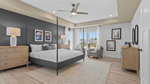 Eye-catching details and elegant finishes in the vibrant primary suite of this select home