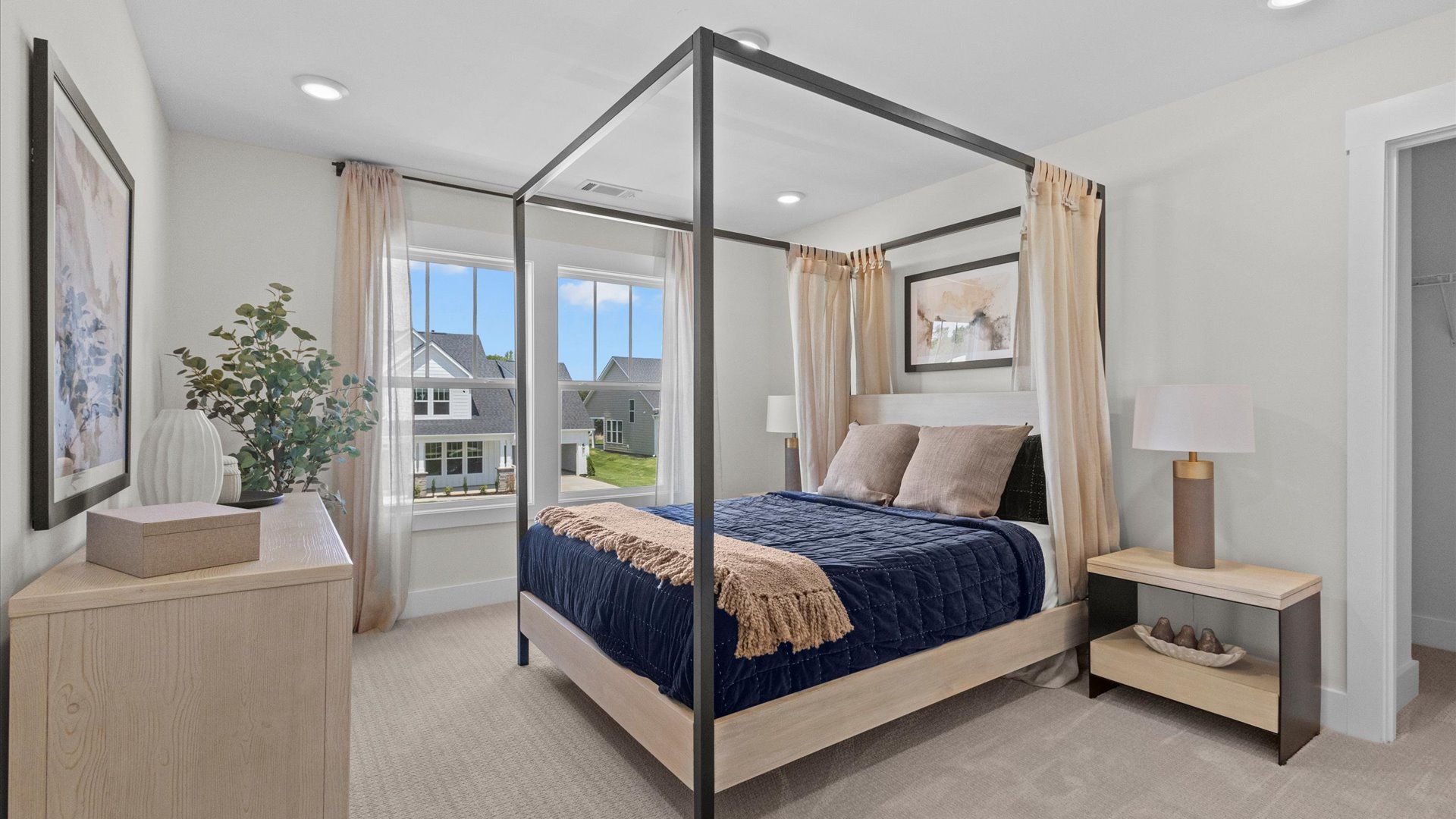 Superior comfort in this light-filled bedroom with plush carpeting and thoughtfully placed large windows