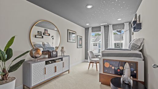 Plush carpeted secondary bedroom with large windows in two story townhome at Ransdell Pointe by DRB Homes in Spartanburg, SC