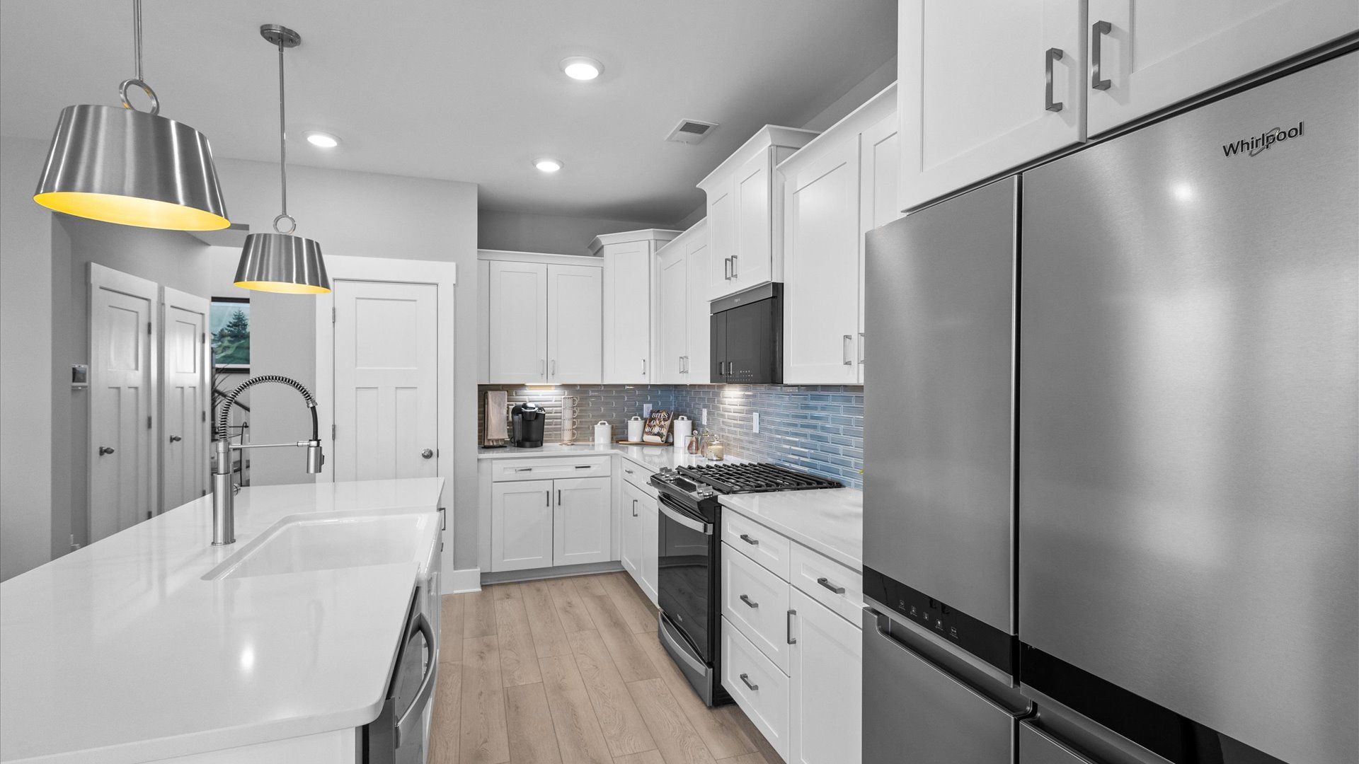 Mint home plan kitchen with center island and tile backsplash