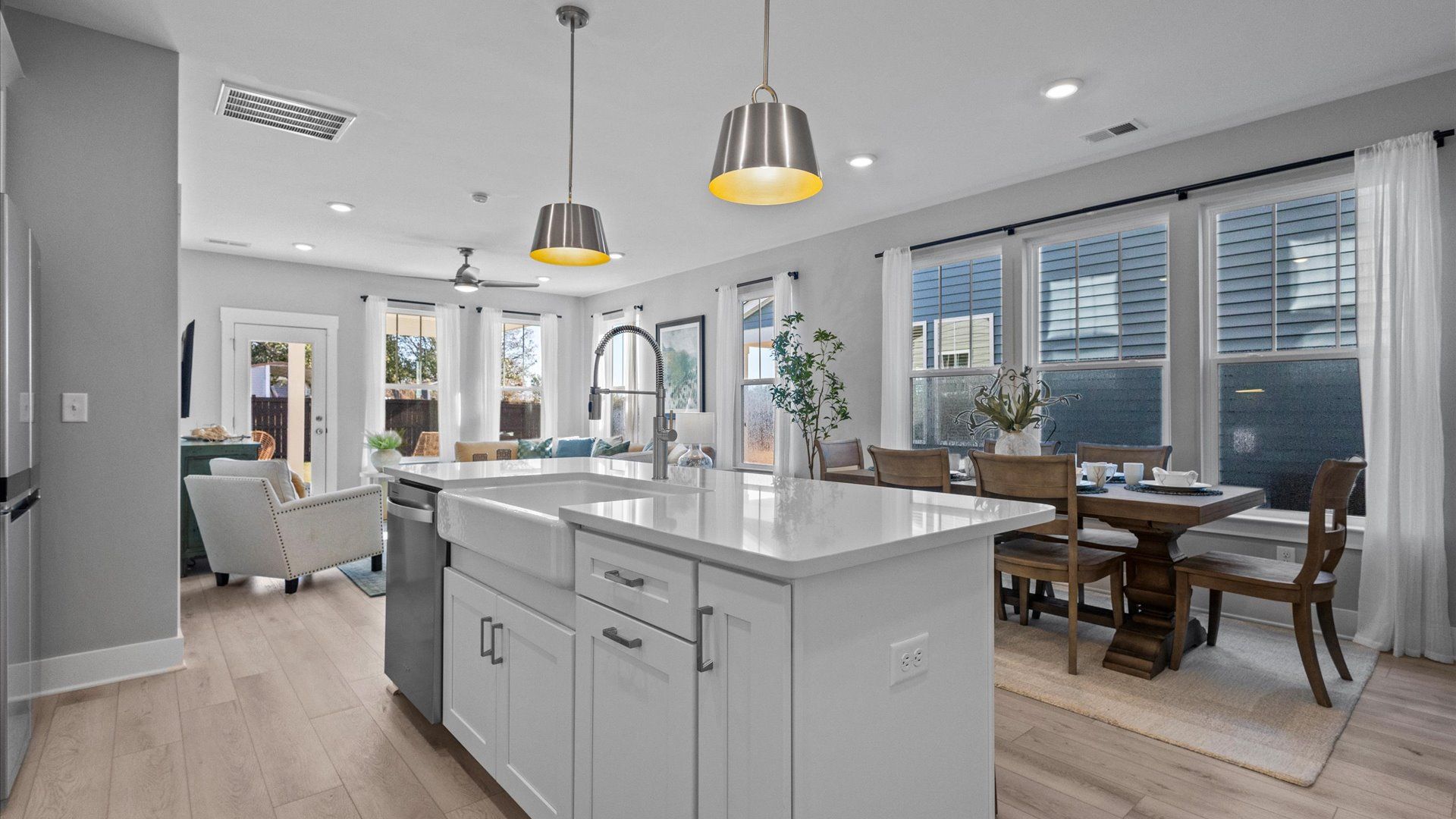 Mint home plan kitchen with center island overlooking breakfast and family room