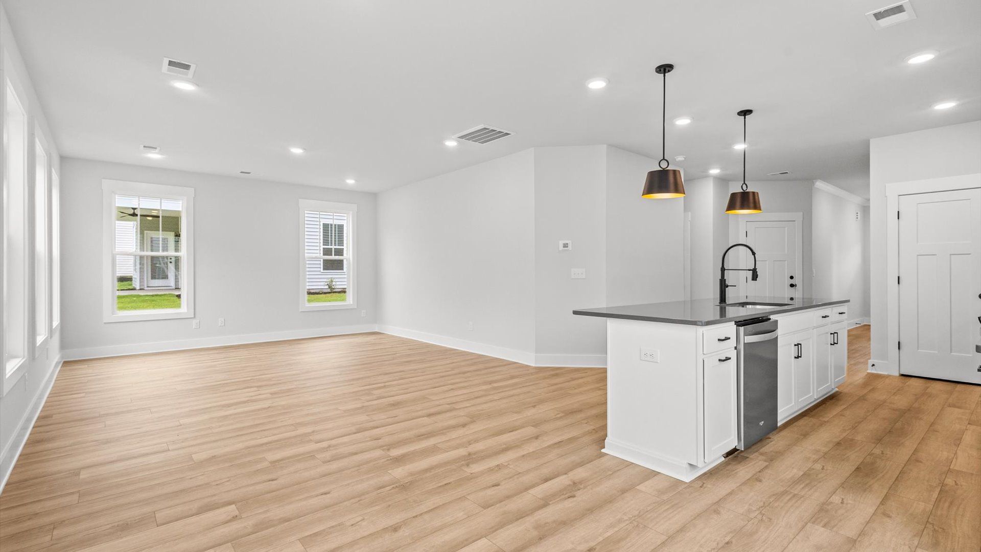 Neroli home plan open concept kitchen with large island overlooking spacious family room and breakfast area