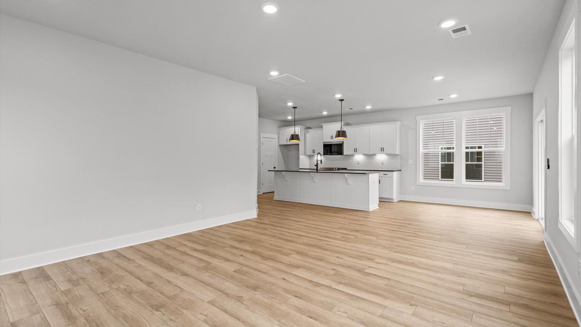 Neroli home plan open concept kitchen with large island overlooking spacious family room and breakfast area