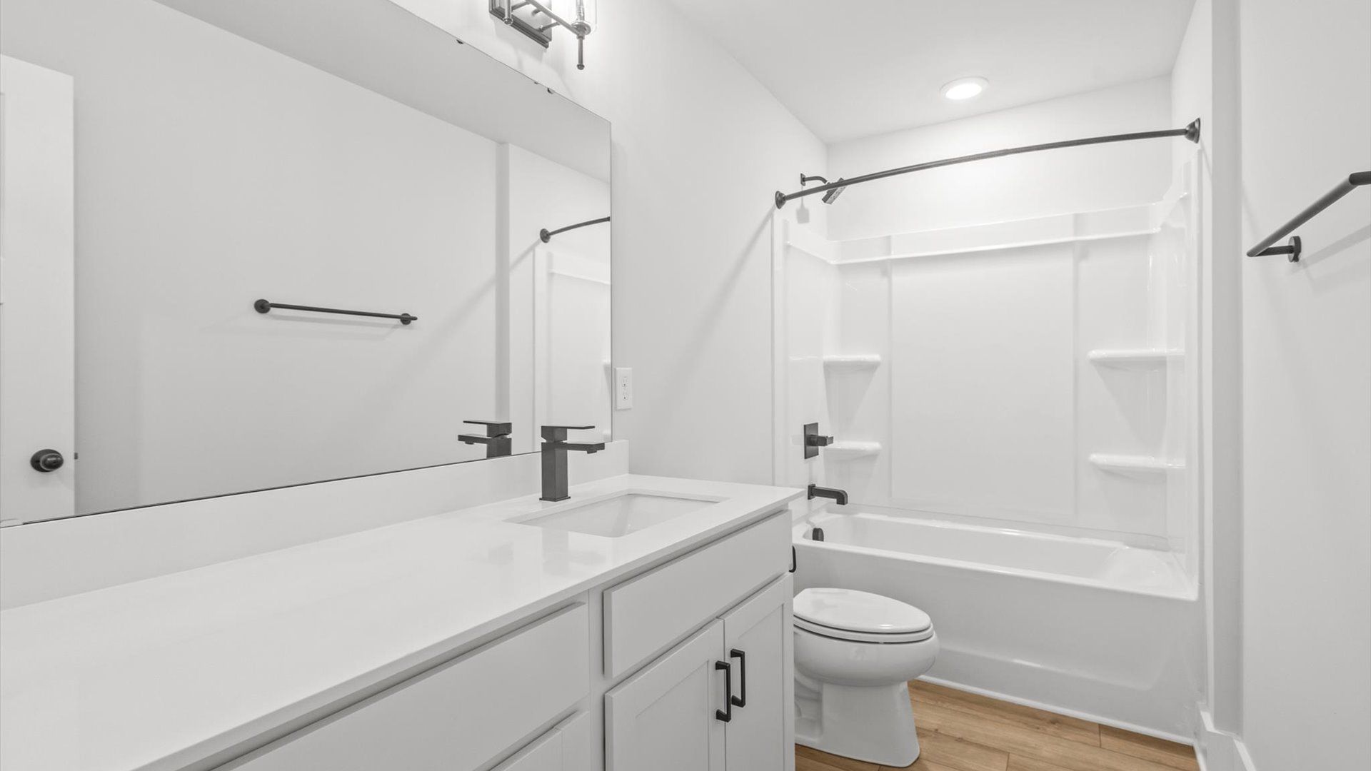 Neroli home plan secondary bathroom with dual vanities and shower/tub combo