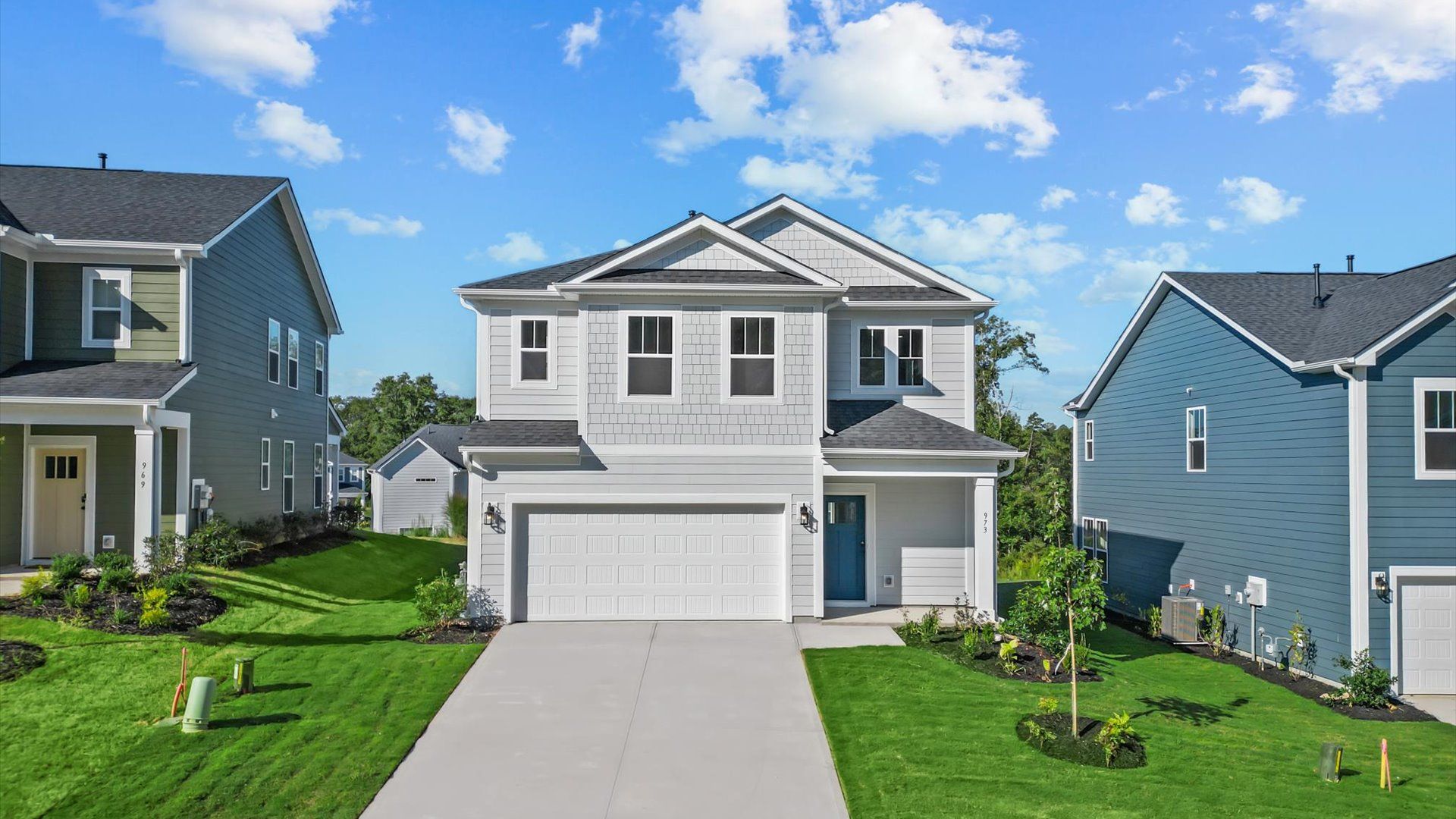 Exceptional two-story home with all white exterior, two-car garage, long driveway, and covered front porch in Woodruff, SC