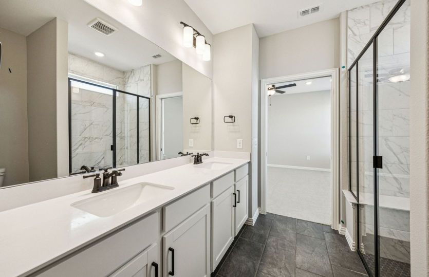 Primary bath with large shower, tub, and double vanity