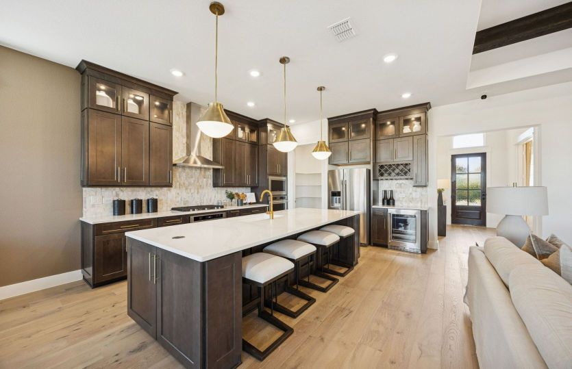 Spacious kitchen with recessed and pendant lighting