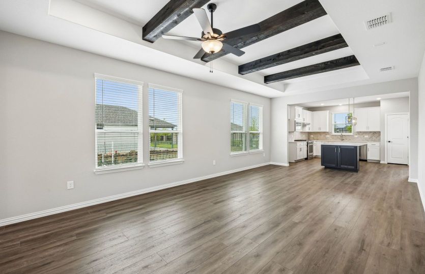Open concept gathering room with tray ceilings