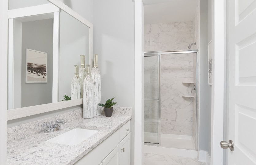Additional Bathroom with a framed walk-in shower. Model Representation.