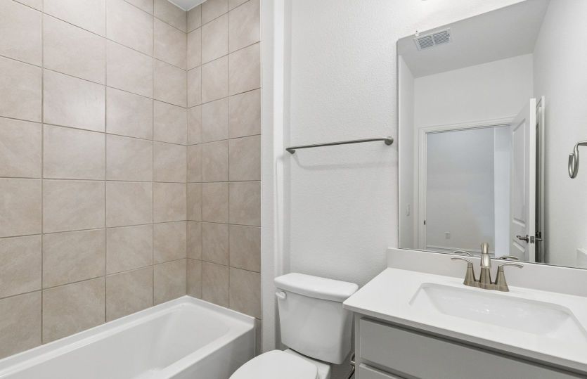 Tile surrounded secondary bathroom