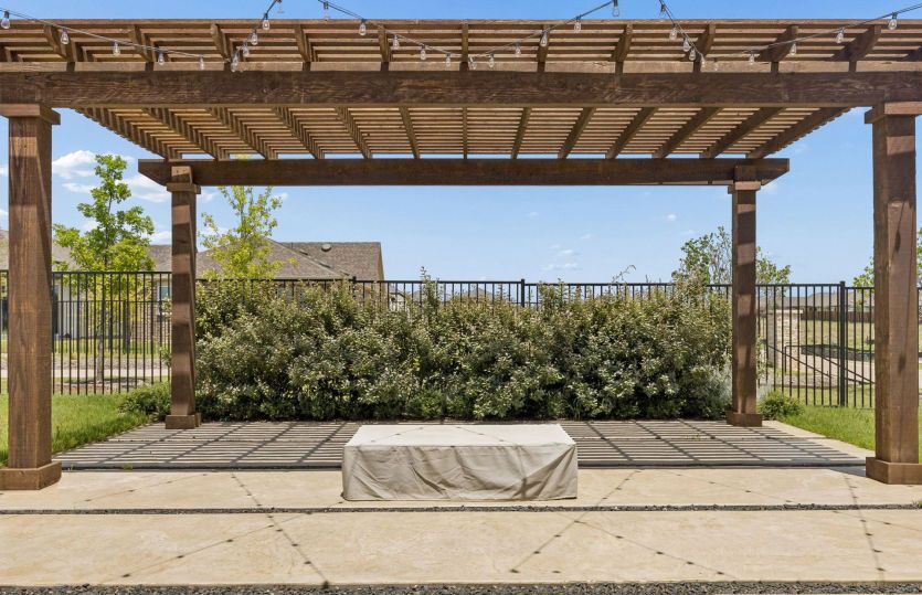 Pergola off back of home with fire pit