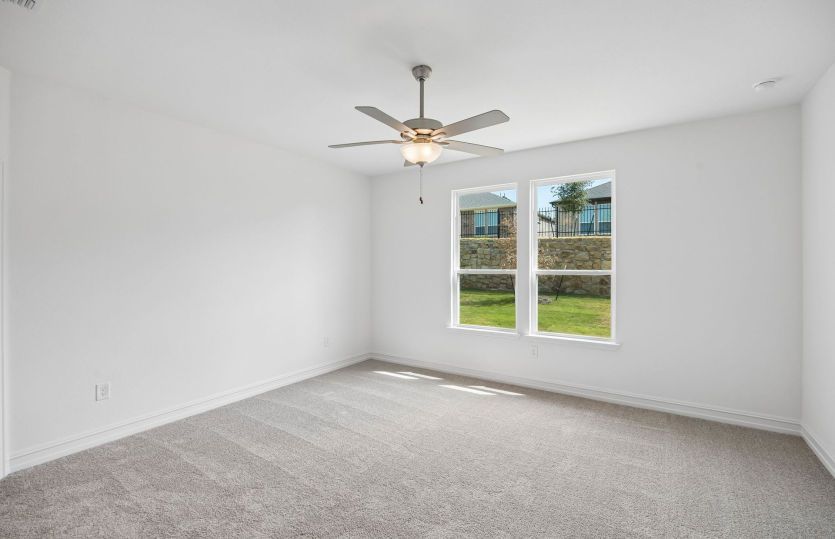 Primary bedroom with large windows