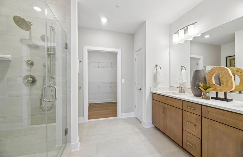 Frameless Shower with a Bench and Ceramic Tile in the Owner's Bathroom