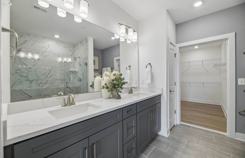 Owner's Bath with Dual Sinks and a Frameless Walk-in Shower