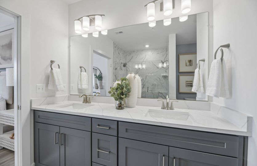 Owner's Bath with Dual Sinks and a Frameless Walk-in Shower