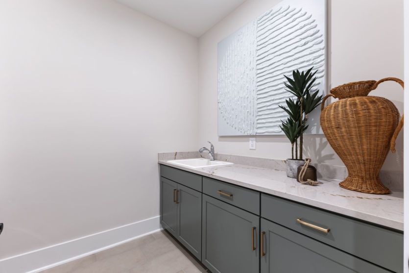 Laundry room with additional storage.
