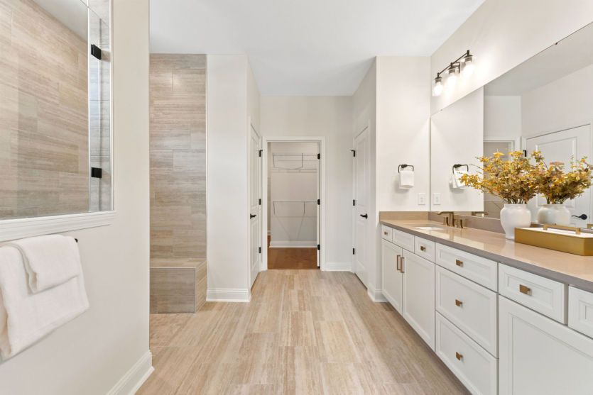 Modern owner's suite bathroom with functional design.