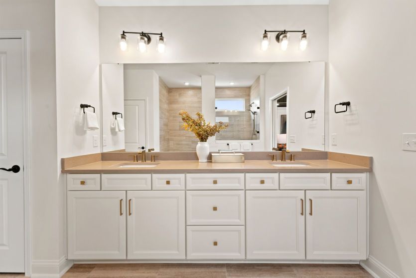 Modern owner's suite bathroom with functional design.