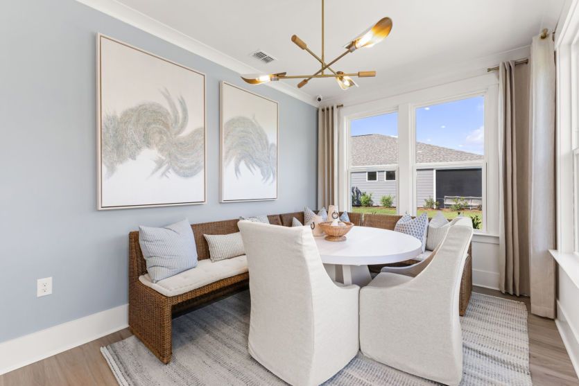 Serene window-filled sunroom that can serve as an at-home get-away for relaxation.