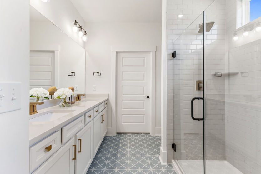 Elegant Owner's Bath with a tile walk-in shower and spacious dual vanity.