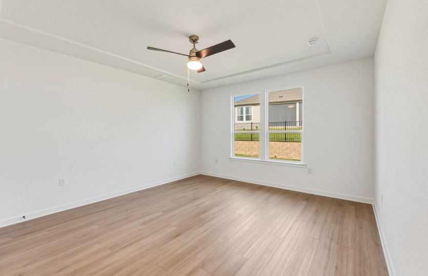 Primary bedroom with large windows
