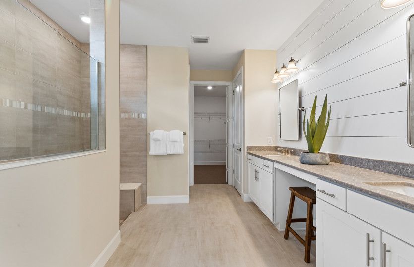 Owners bathroom with dual sink vanity and walk-in shoer