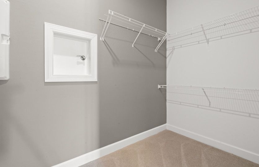 Owner's closet with pass through to the laundry room