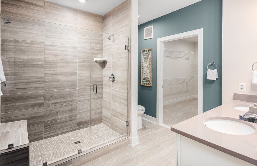 Luxurious Owner's Bath featuring a Frameless Shower and a Double Bowl Sink - Model Representation