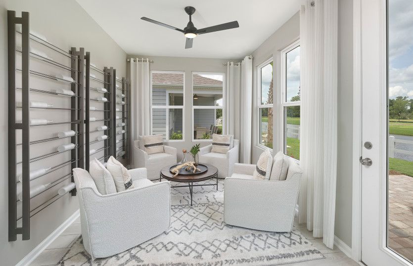 Serene window-filled sunroom that can serve as an at-home get-away for relaxation. Model Representat
