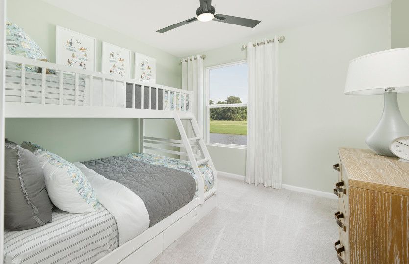 Spacious and welcoming secondary bedrooms with room for your guests to relax. Model Representation.