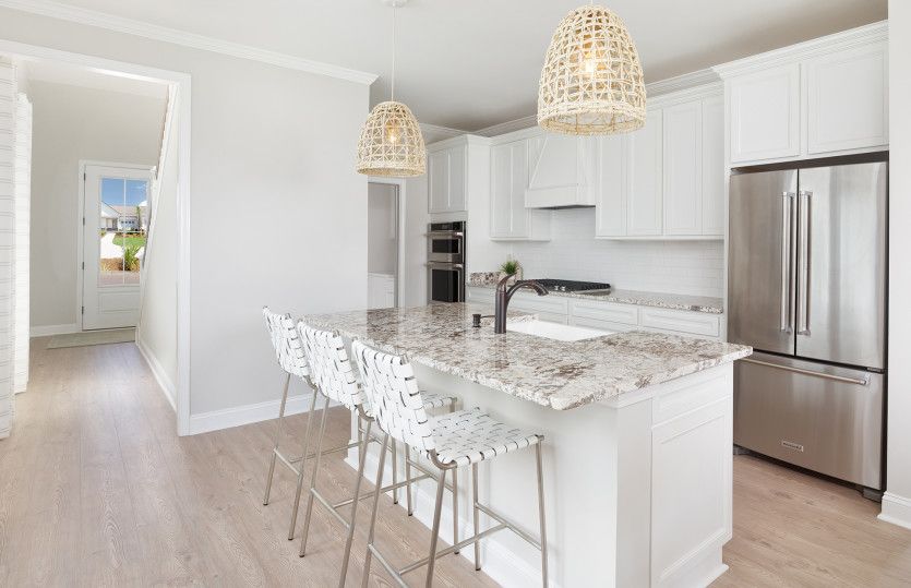 Large large kitchen with an island providing additional seating and counter space. Model Representat