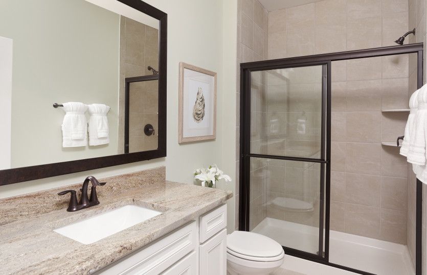 Guest Bathroom with a bronze finished walk-in shower. Model Representation.