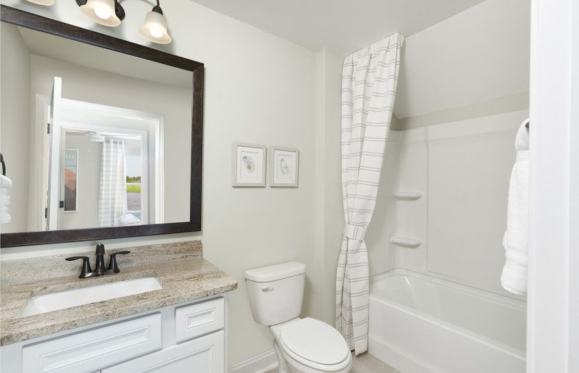 Secondary Bathroom with a soaking tub for relaxation. Model Representation.