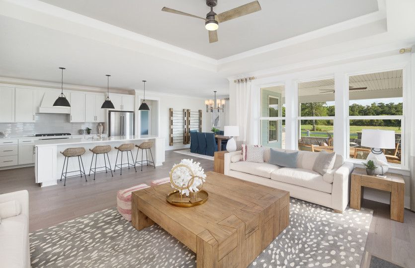 Bright and airy oversized Gathering Room with elegant  engineered wood flooring.