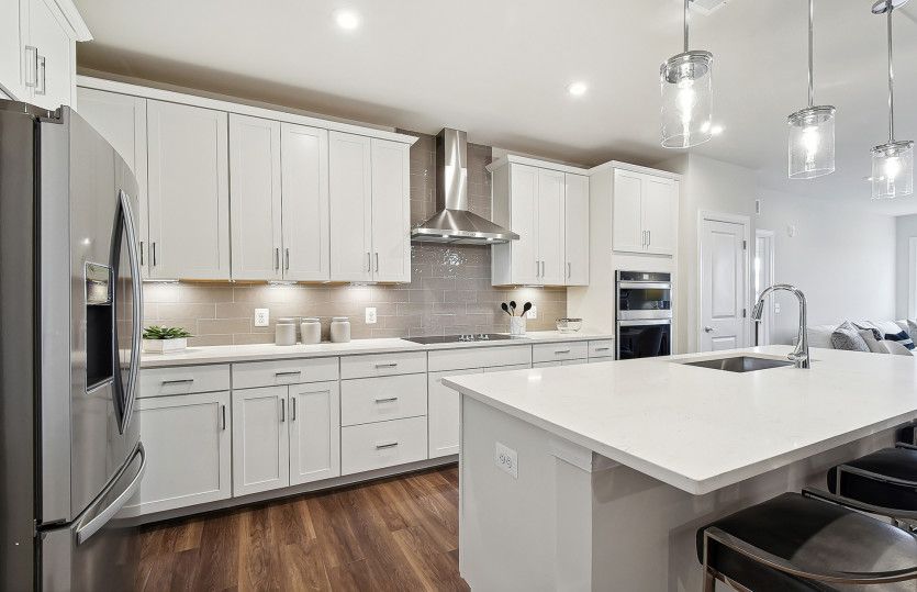 White Cabinetry and Quartz Countertops in the Gourmet Kitchen